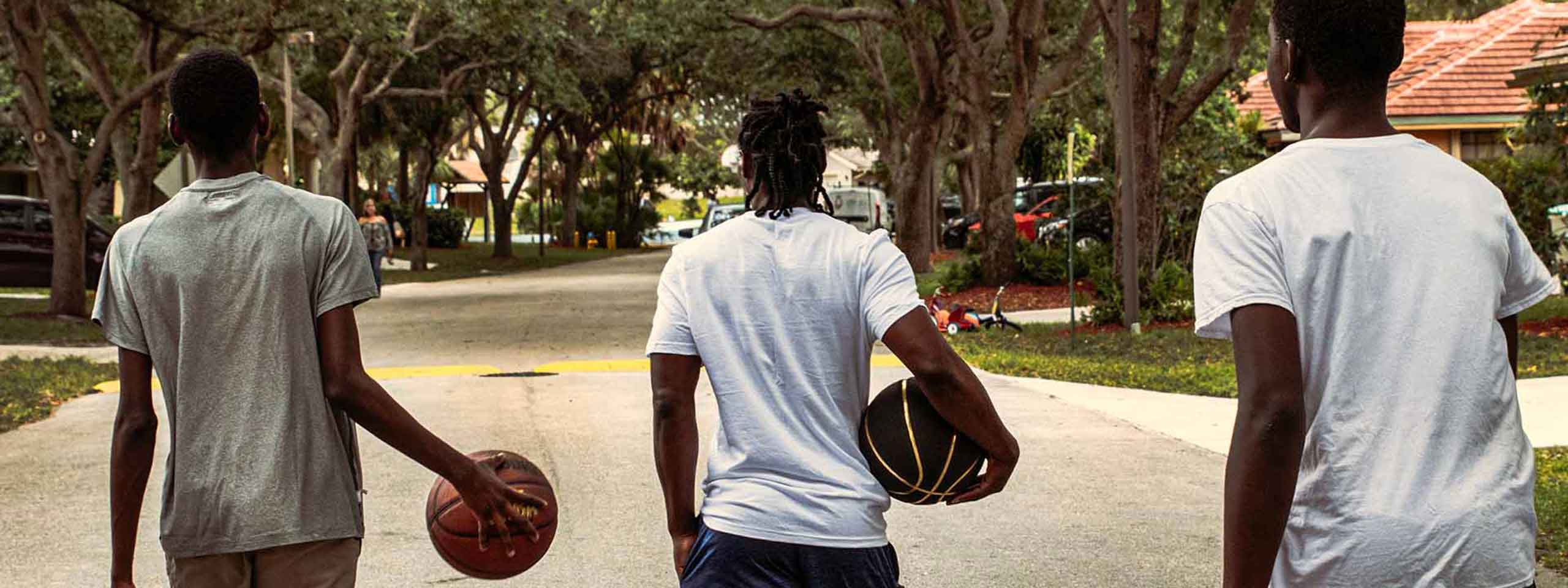 Männer von hinten mit Basketbällen