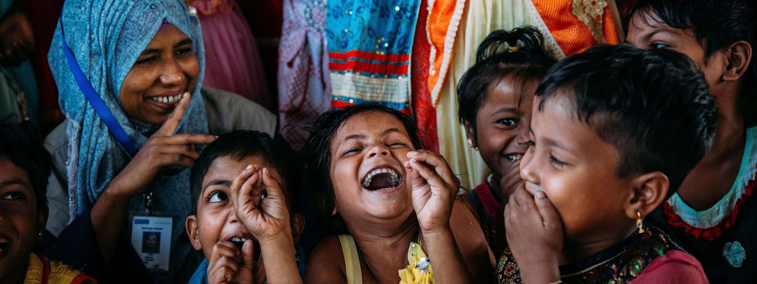 group of children and women laughing