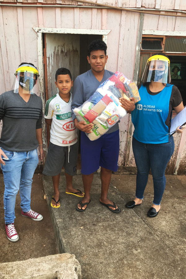 SOS-Mitarbeiter in Brasilien versorgen eine Familie mit Grundnahrungsmitteln