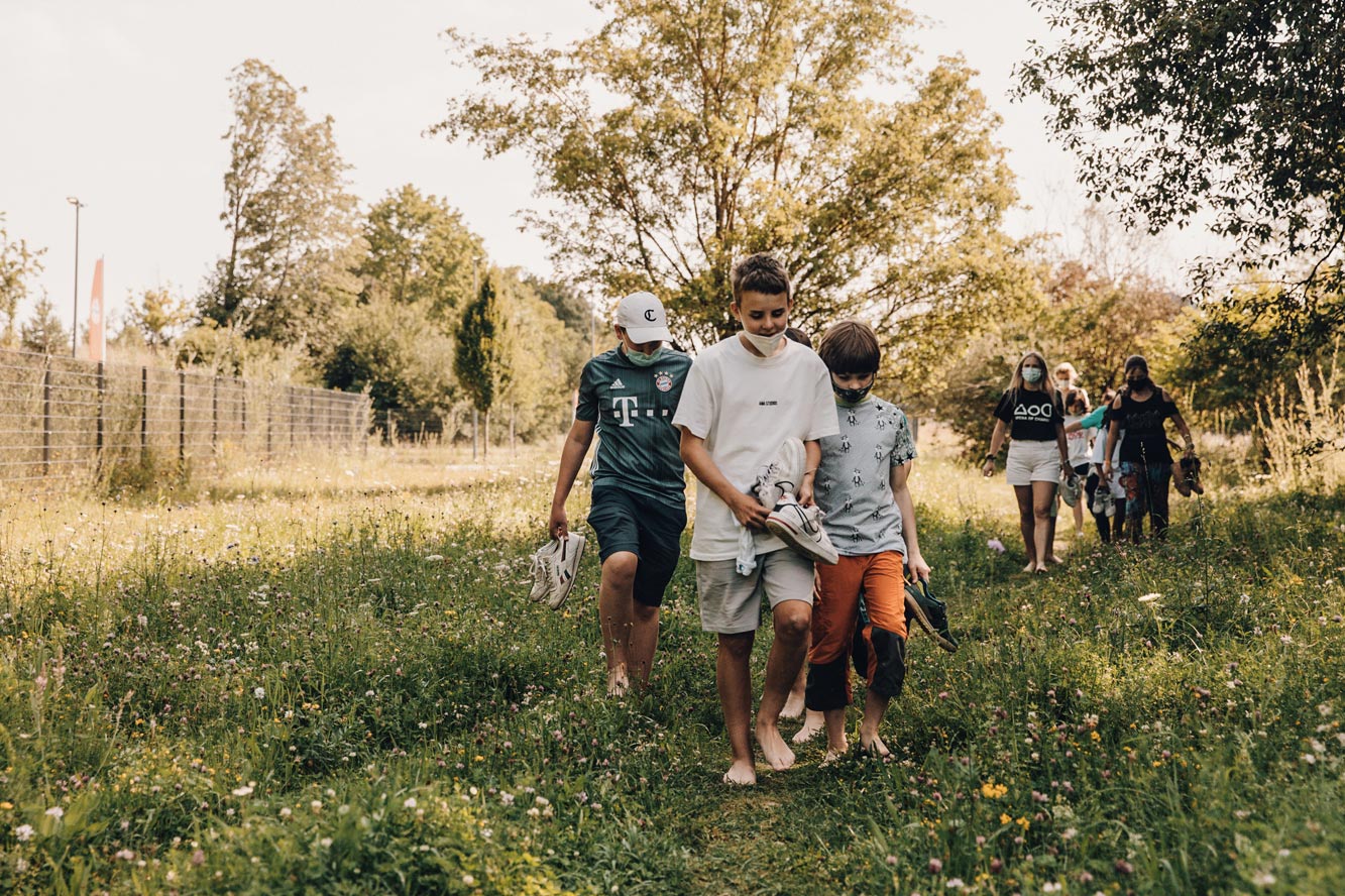 Kinder gehen über eine Wiese